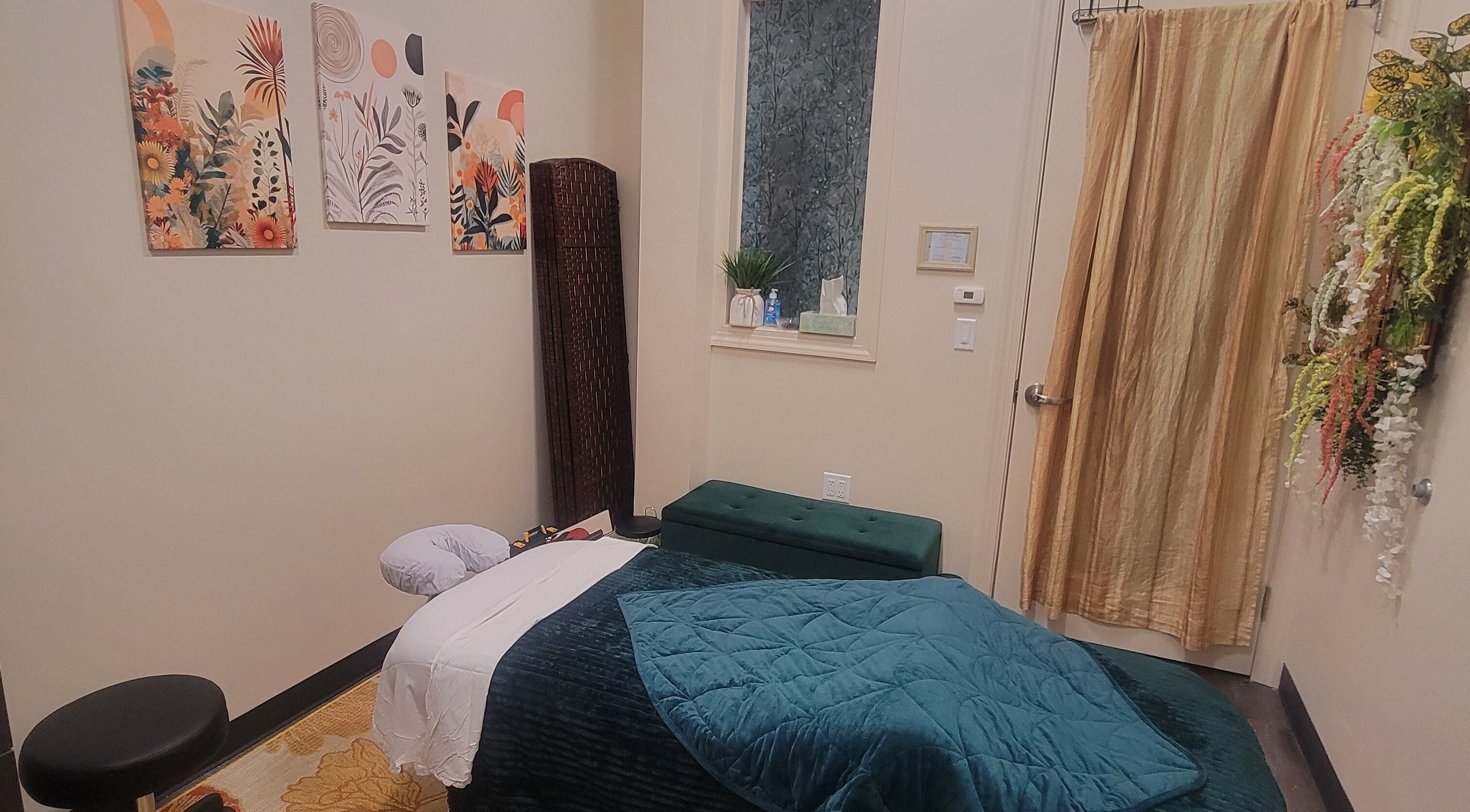 Cozy massage room at Taylored Spa and Massage, Bayonne, New Jersey, US with warm decor and relaxing ambiance.