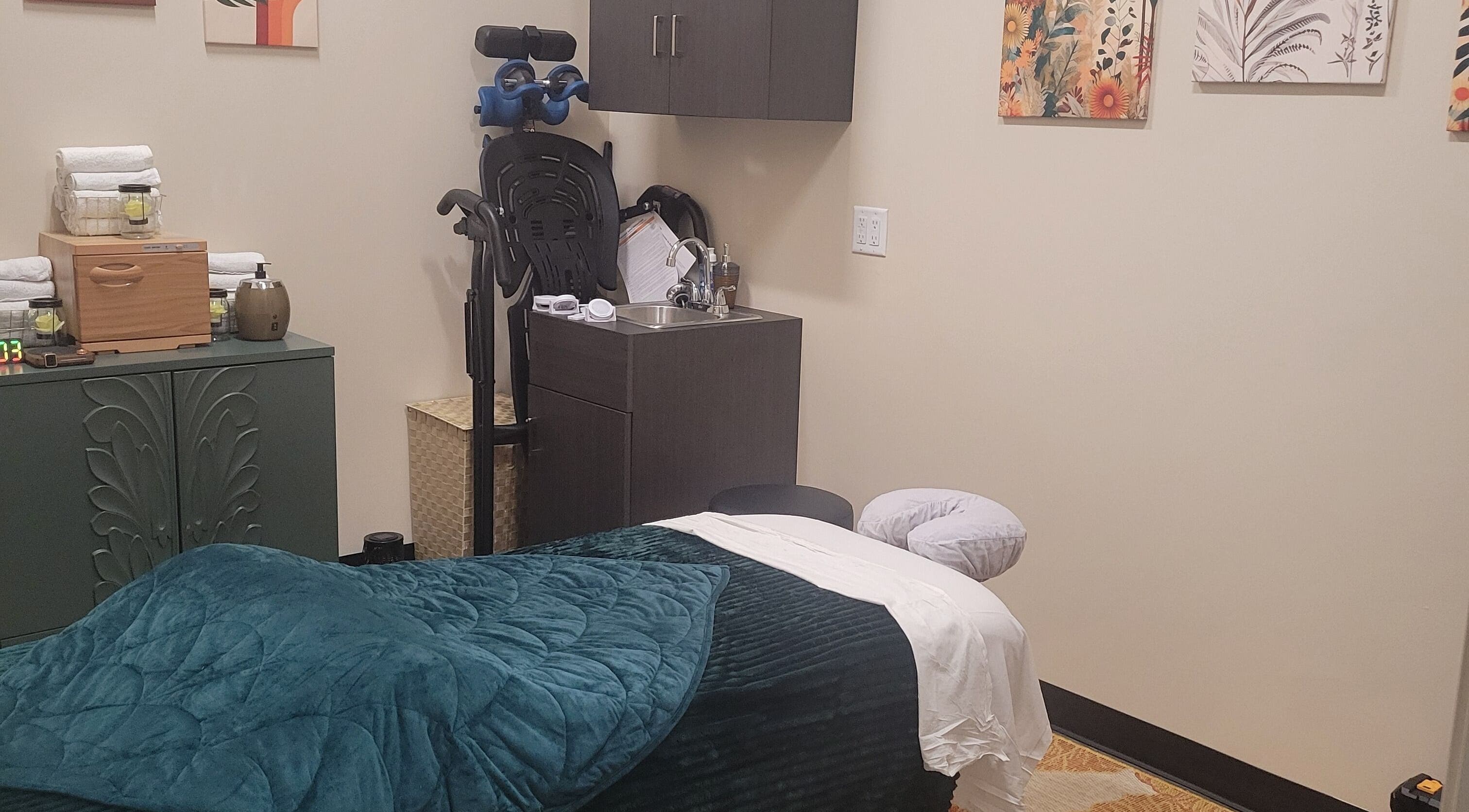 Cozy massage room at Taylored Spa and Massage in Bayonne, New Jersey, US, featuring a plush treatment table.