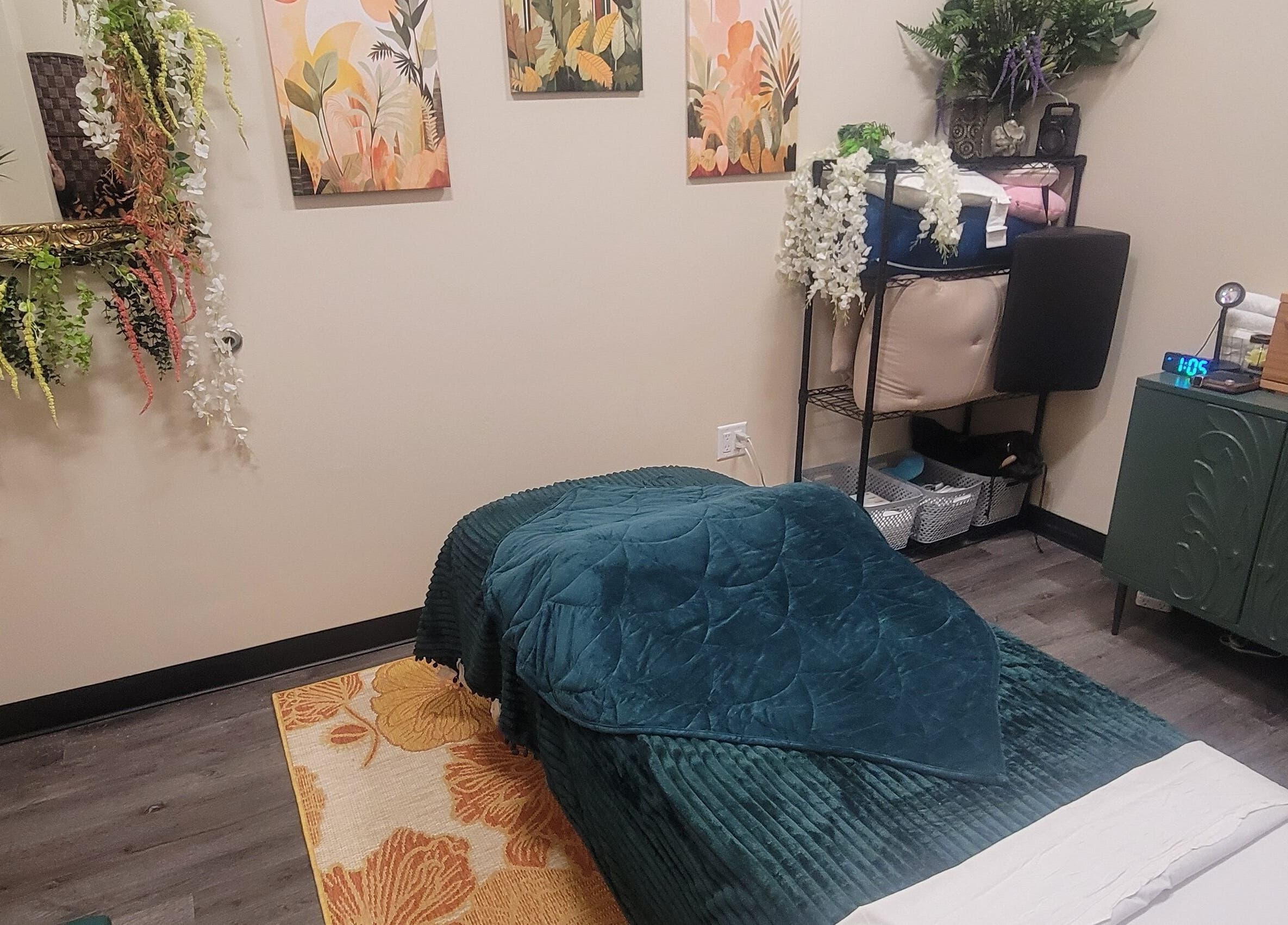 Cozy massage room at Taylored Spa and Massage, Bayonne, New Jersey, US, featuring relaxing decor and bed.