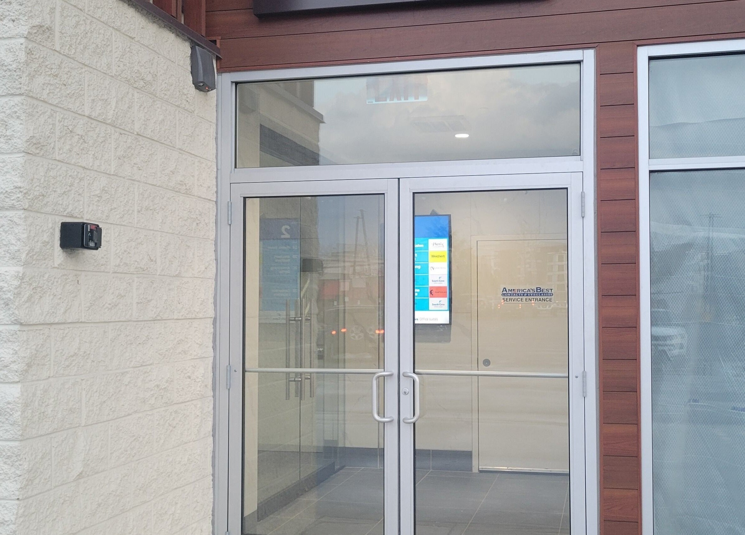 Sleek entrance of Taylored Spa and Massage in Bayonne, New Jersey, US showcasing modern glass doors.
