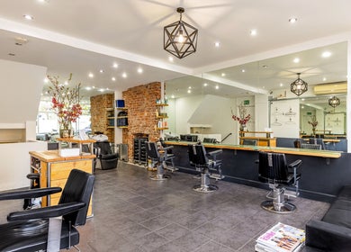 Modern interior of Hikari Salon in London, England, GB, featuring sleek black chairs and stylish decor.
