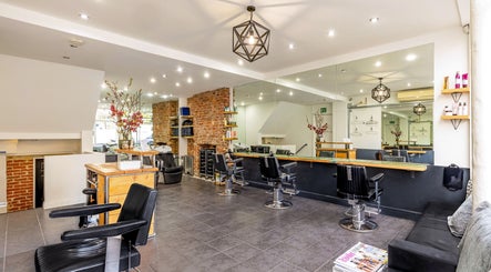 Modern interior of Hikari Salon in London, England, GB, featuring sleek black chairs and stylish decor.