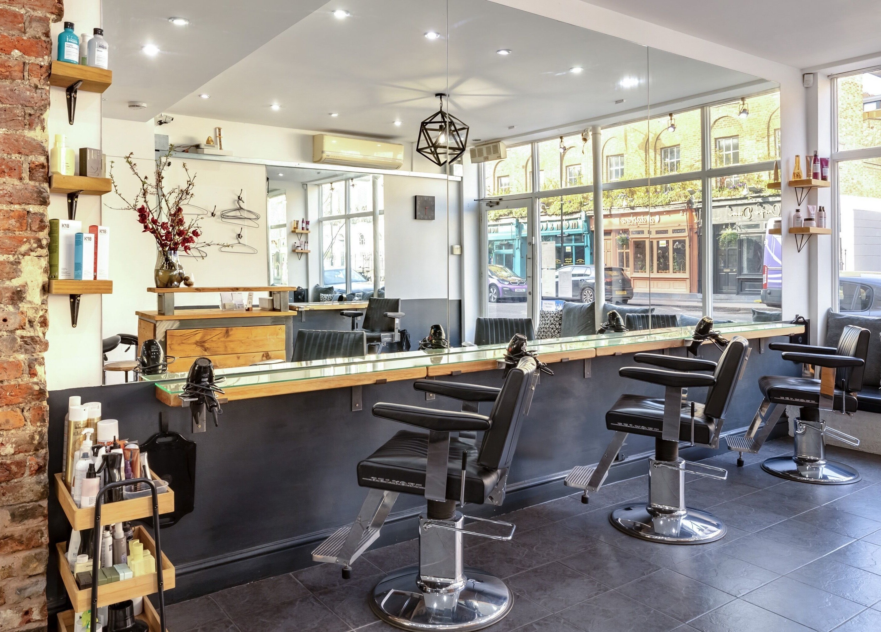Modern interior of Hikari Salon, London, England, GB with sleek salon chairs and large windows.