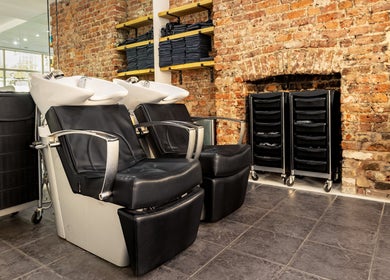 Modern wash stations at Hikari Salon, London, England, GB with exposed brick and sleek design.