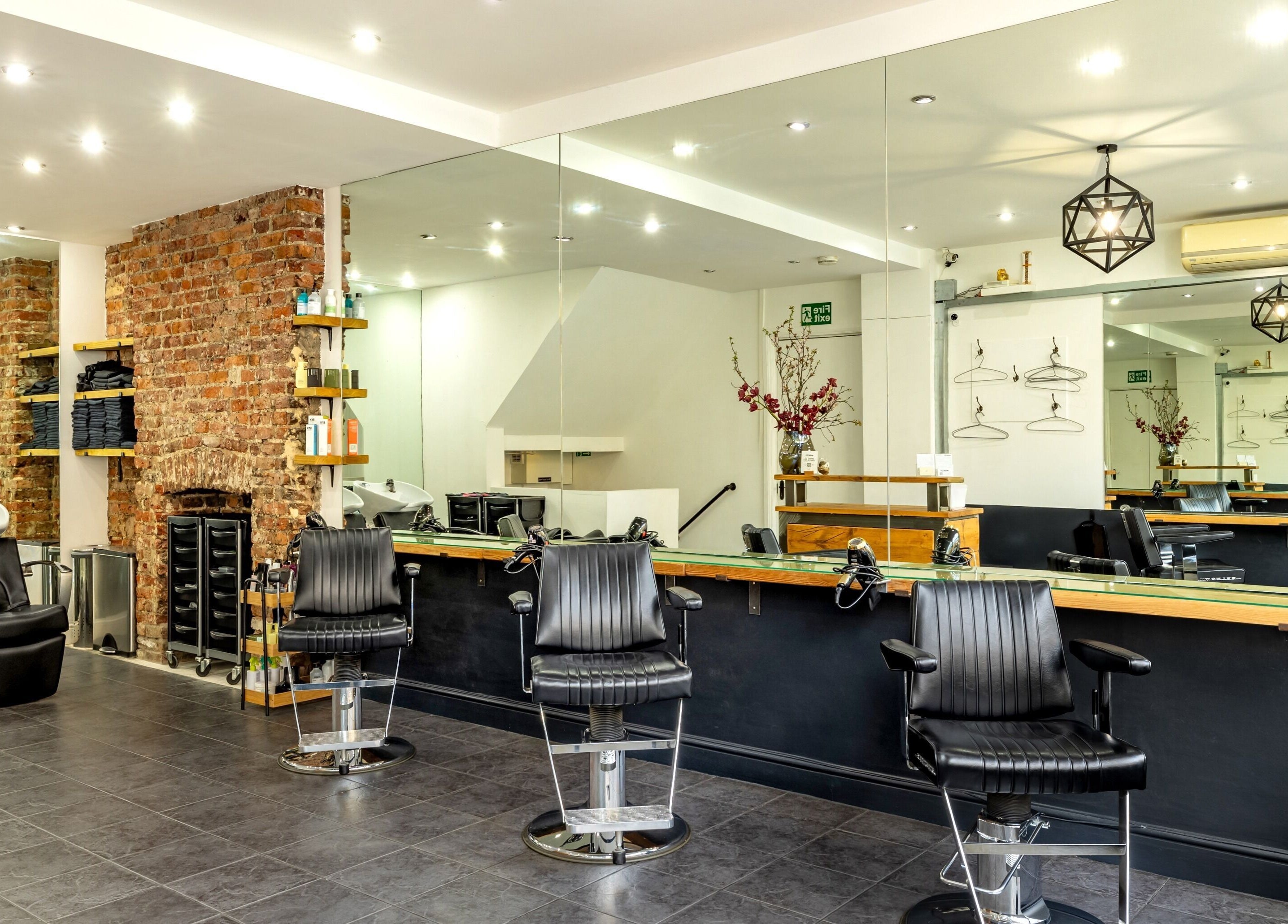 Modern salon interior at Hikari Salon, London, England, GB, featuring stylish chairs and mirrors.