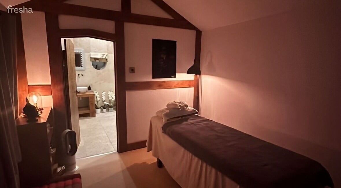 Relaxing treatment room at La'or Beauty & Spa, Bury, England, GB, featuring a cozy massage bed and warm lighting.