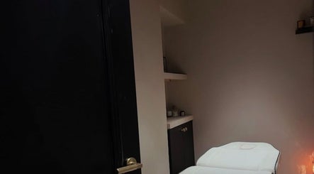 Cozy treatment room at Phace, Swinton, England, GB with a comfortable massage bed and ambient lighting.