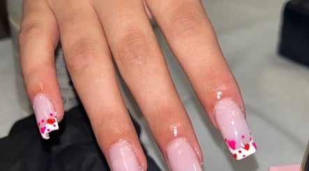 Elegant pink nails with heart tips at Luxe Lush, Holywell, Flintshire, GB.