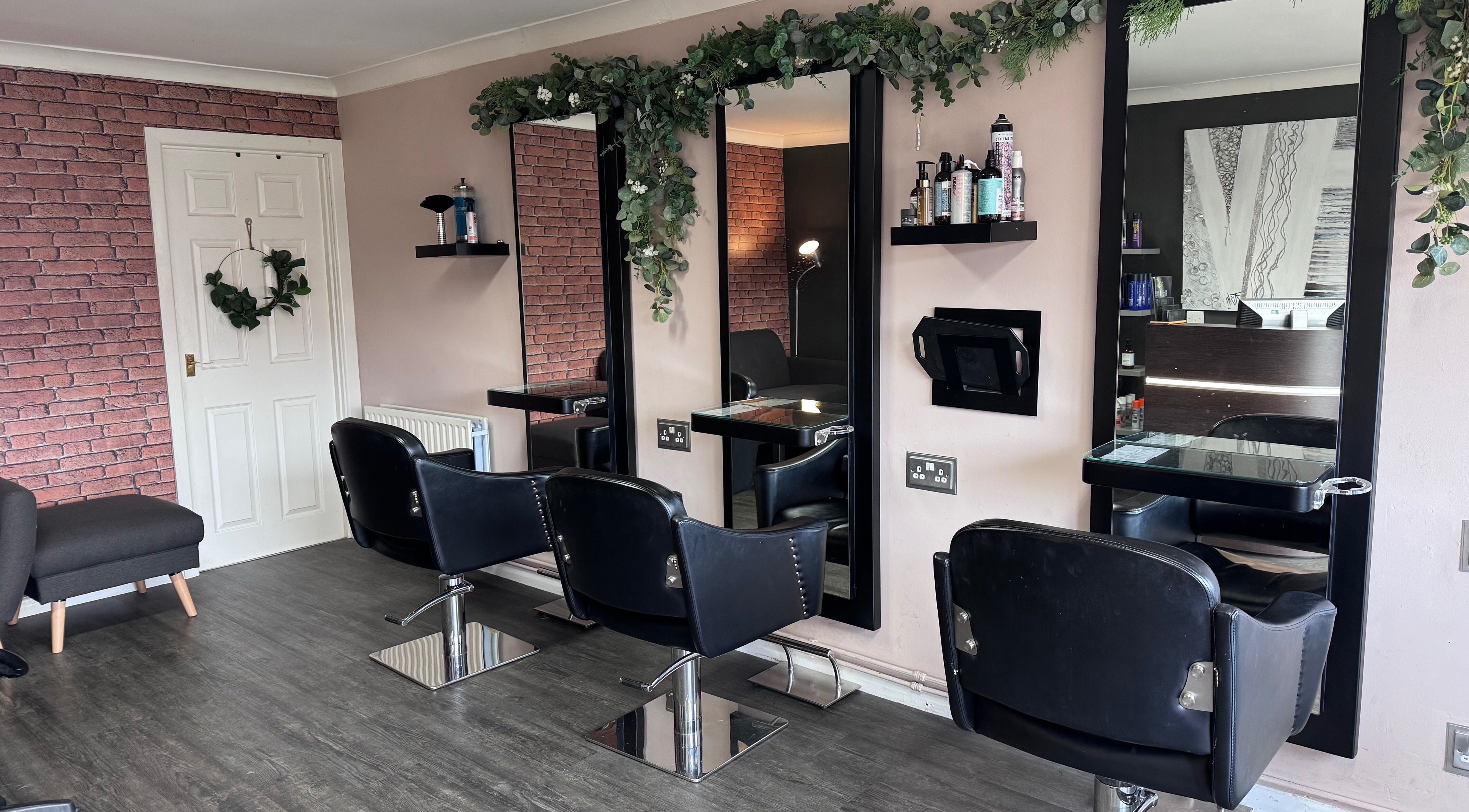Modern salon chairs and mirrors at Hair by Emma at Xclusive in Bournemouth, England, GB.