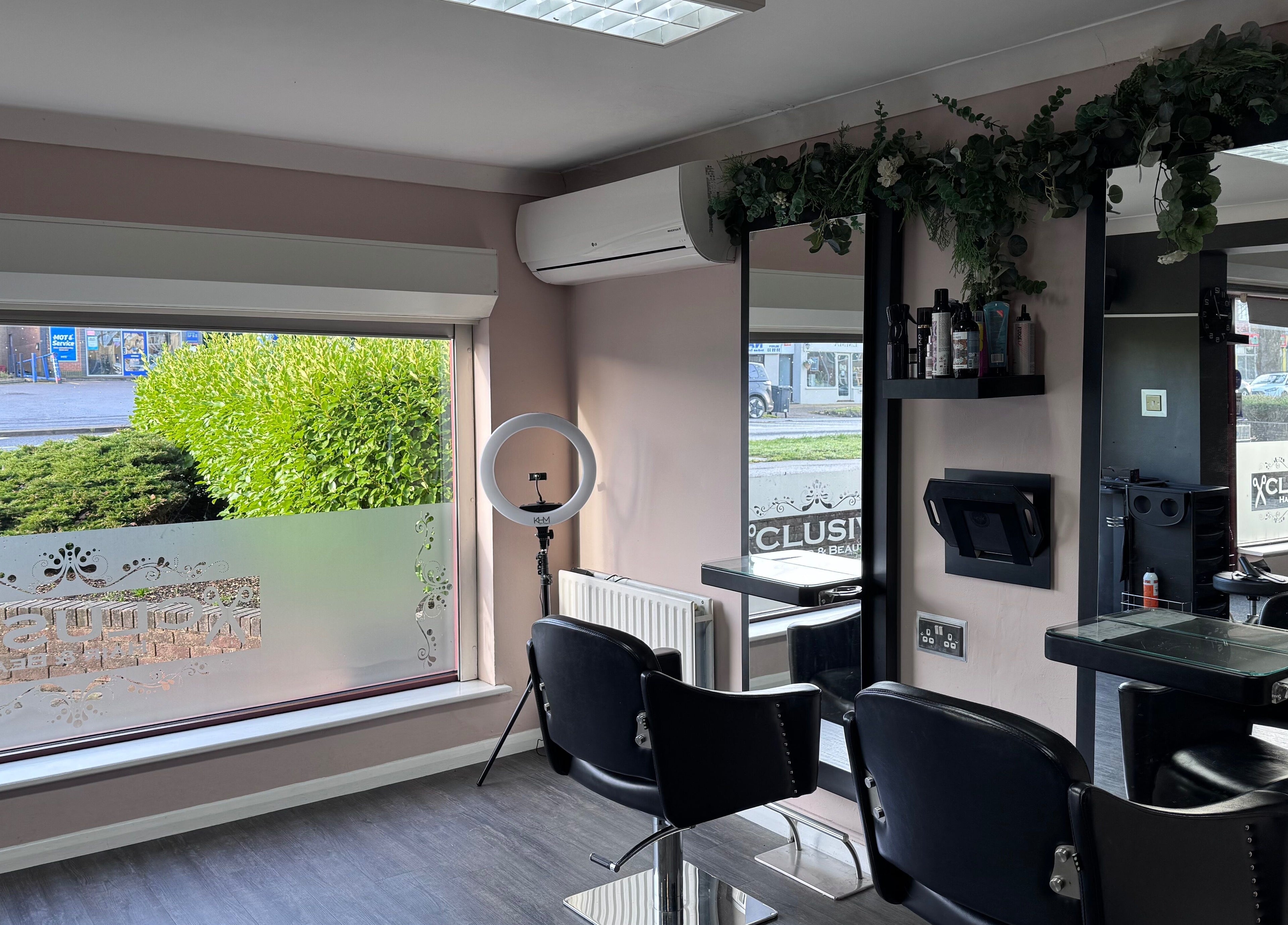 Stylish salon interior at Hair by Emma at Xclusive, Bournemouth, England, GB featuring modern decor and seating.