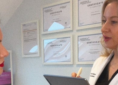 Professional consultation at Kati Aesthetics in London, England with certificates on display.