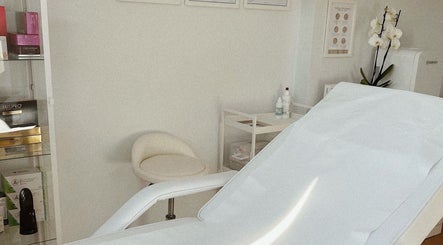 A calming treatment room at Kati Aesthetics, London, England, GB, featuring a reclining chair and organized shelf.