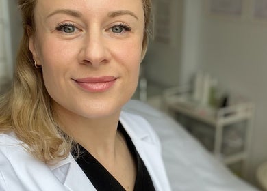 Friendly aesthetician at Kati Aesthetics, London, England, GB, ready for a wellness session.