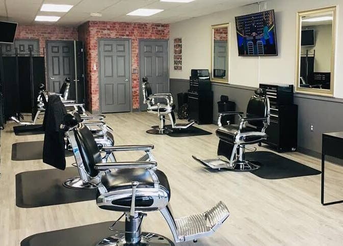 Modern interior of In the Cut Barbershop in Long Beach, California, US with stylish barber chairs.
