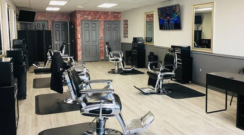 Modern interior of In the Cut Barbershop in Long Beach, California, US with stylish barber chairs.