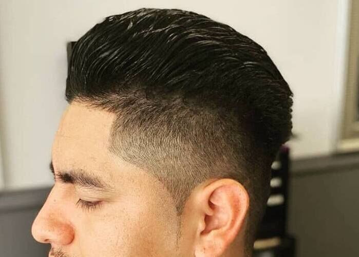 Sleek fade hairstyle at In the Cut Barbershop, Long Beach, California, US. Modern style and precision.