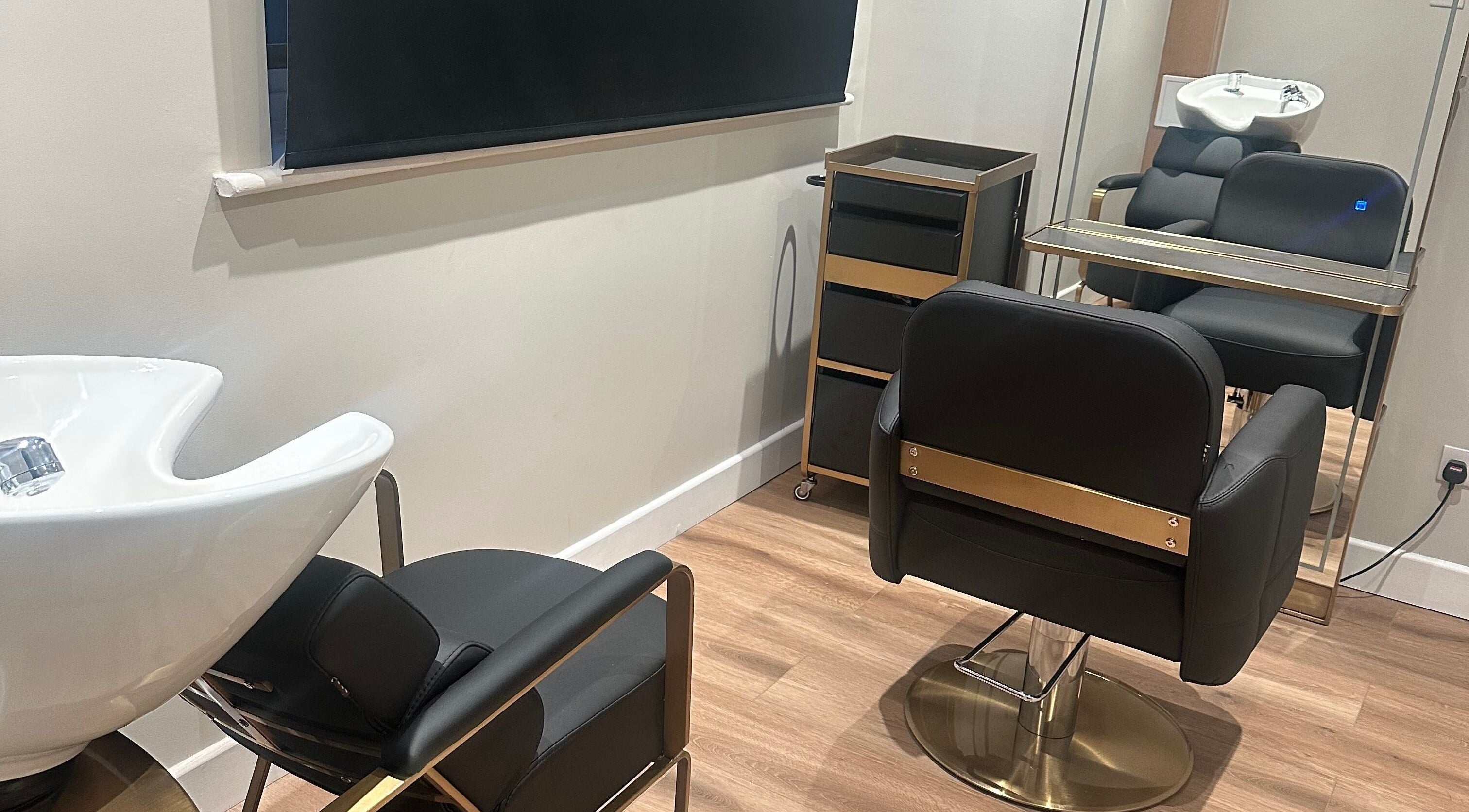 Contemporary hair salon interior at GlamTress✨, featuring stylish chairs and a mirror setup in Luton, England, GB.