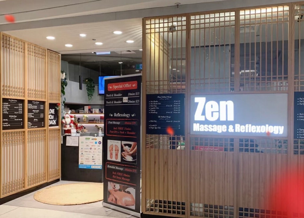 Entrance of Zen Massage & Reflexology in Chatswood, New South Wales, AU featuring illuminated signage and wood paneling.