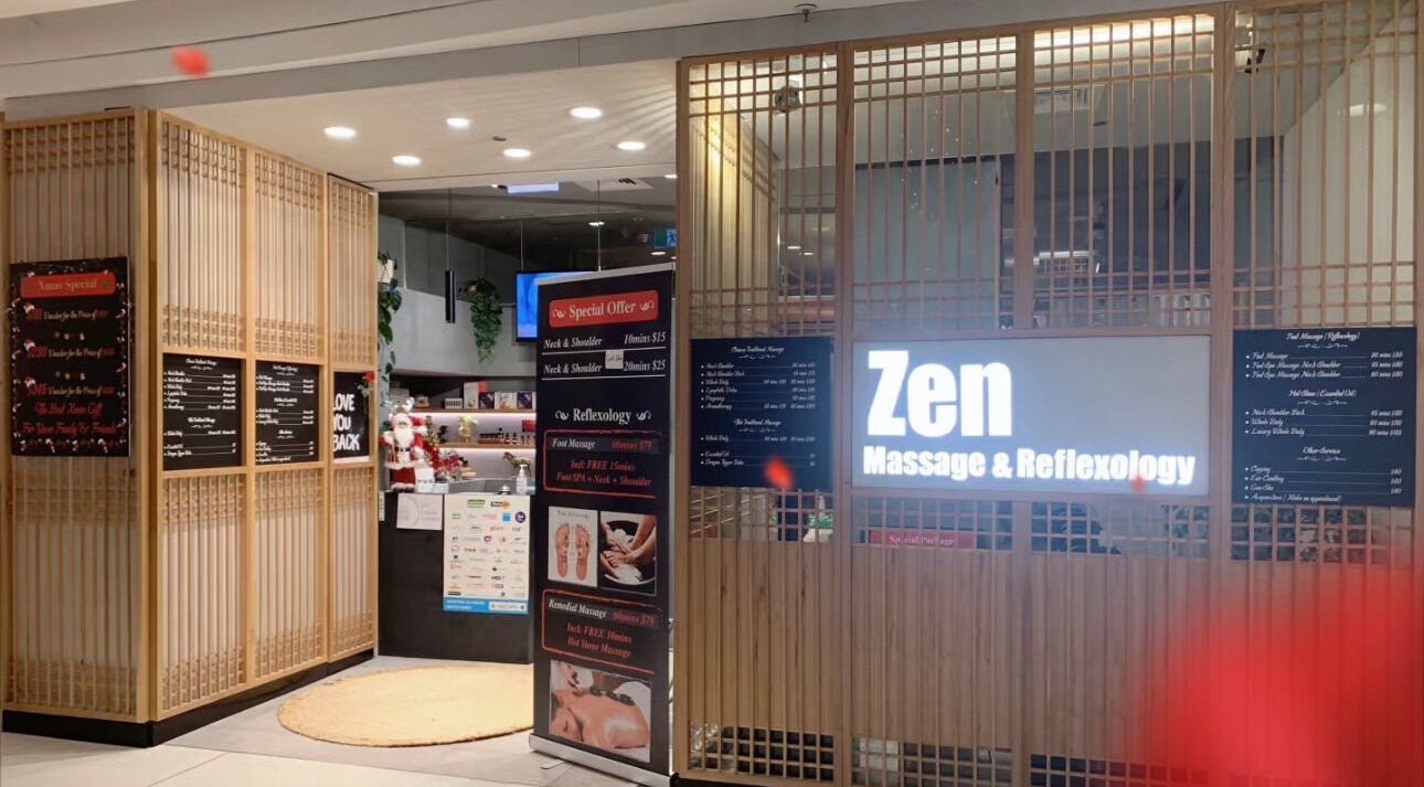 Entrance of Zen Massage & Reflexology in Chatswood, New South Wales, AU featuring illuminated signage and wood paneling.