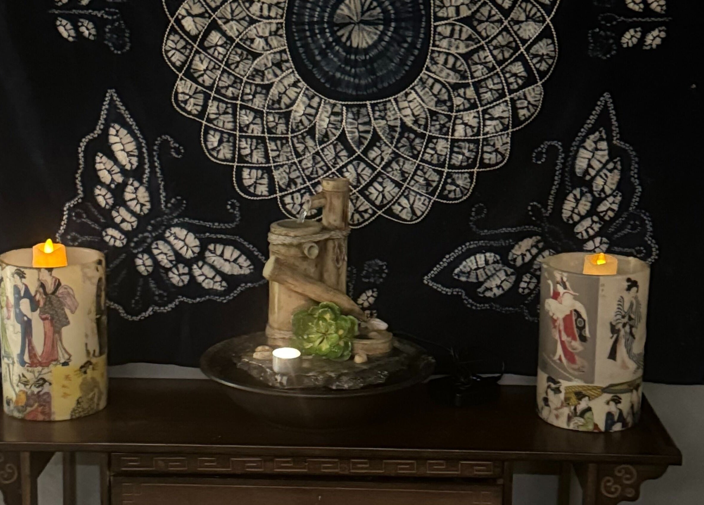 Tranquil decor at Zen Massage & Reflexology, Chatswood, New South Wales, AU, featuring candles and intricate tapestry.