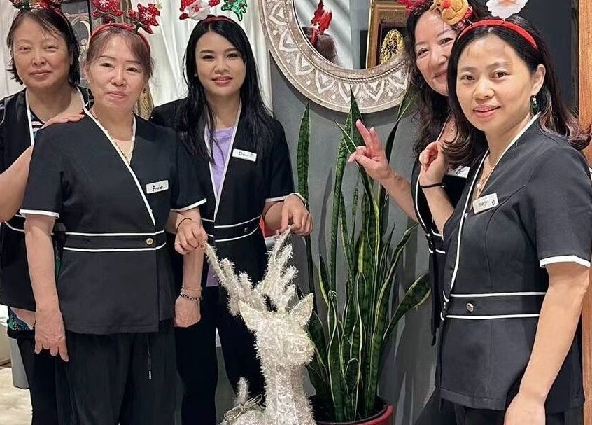 Team at Zen Massage & Reflexology in Chatswood, New South Wales, AU poses with festive decor.