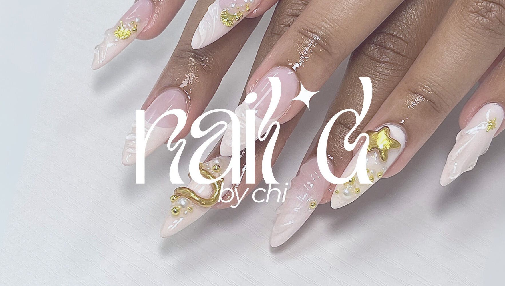 Stylish manicured nails at NAIL'D BY CHI, Pickering, Ontario, CA, featuring exquisite gold embellishments.