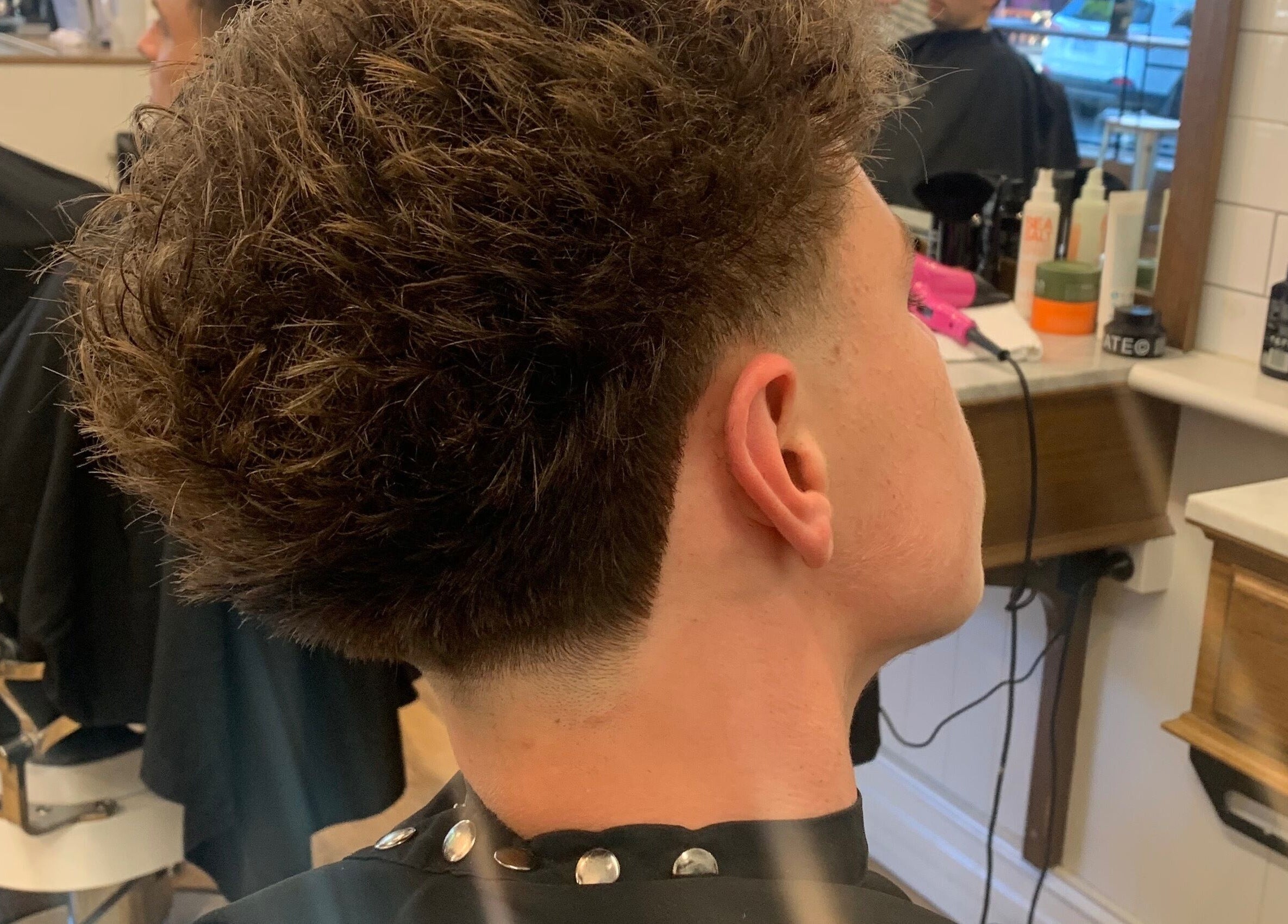 Close-up of a stylish men's haircut at HairbyLiam, Lara, Victoria, AU showcasing expert barber skills.