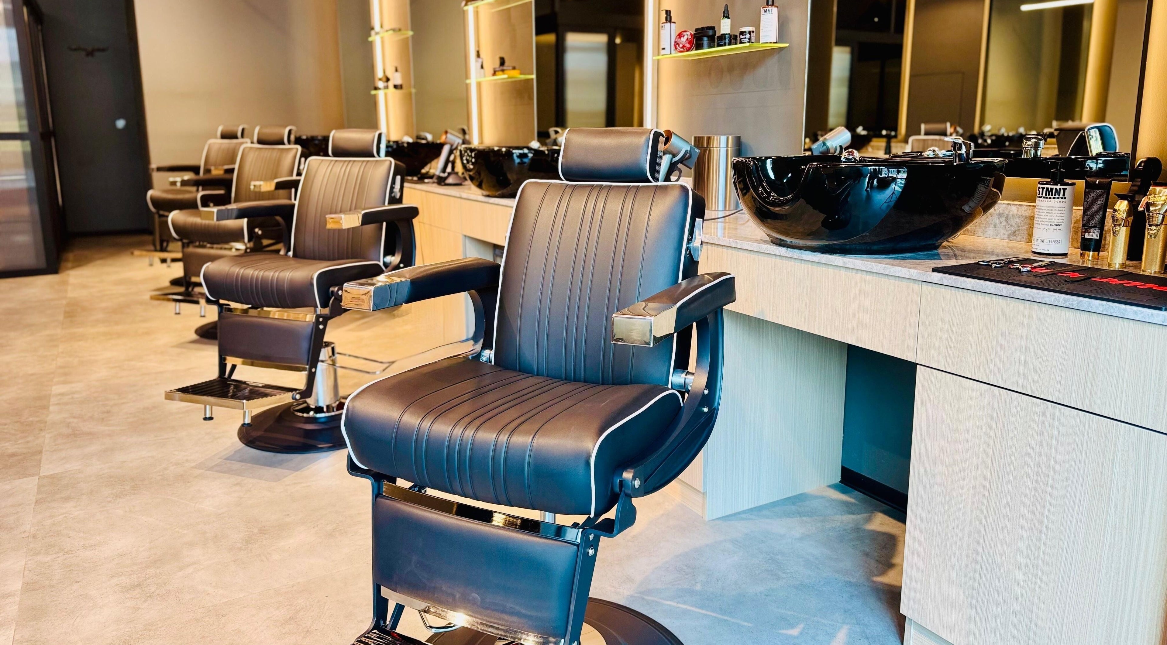 Modern barber chairs and stations at B27 Barbershop, Dubai, AE, showcasing a sleek, stylish interior.