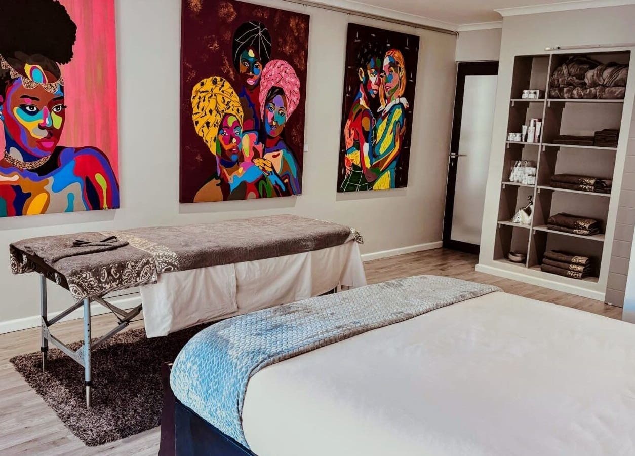 Massage room at Chalila Wellness, Cape Town, with vibrant art and cozy decor.