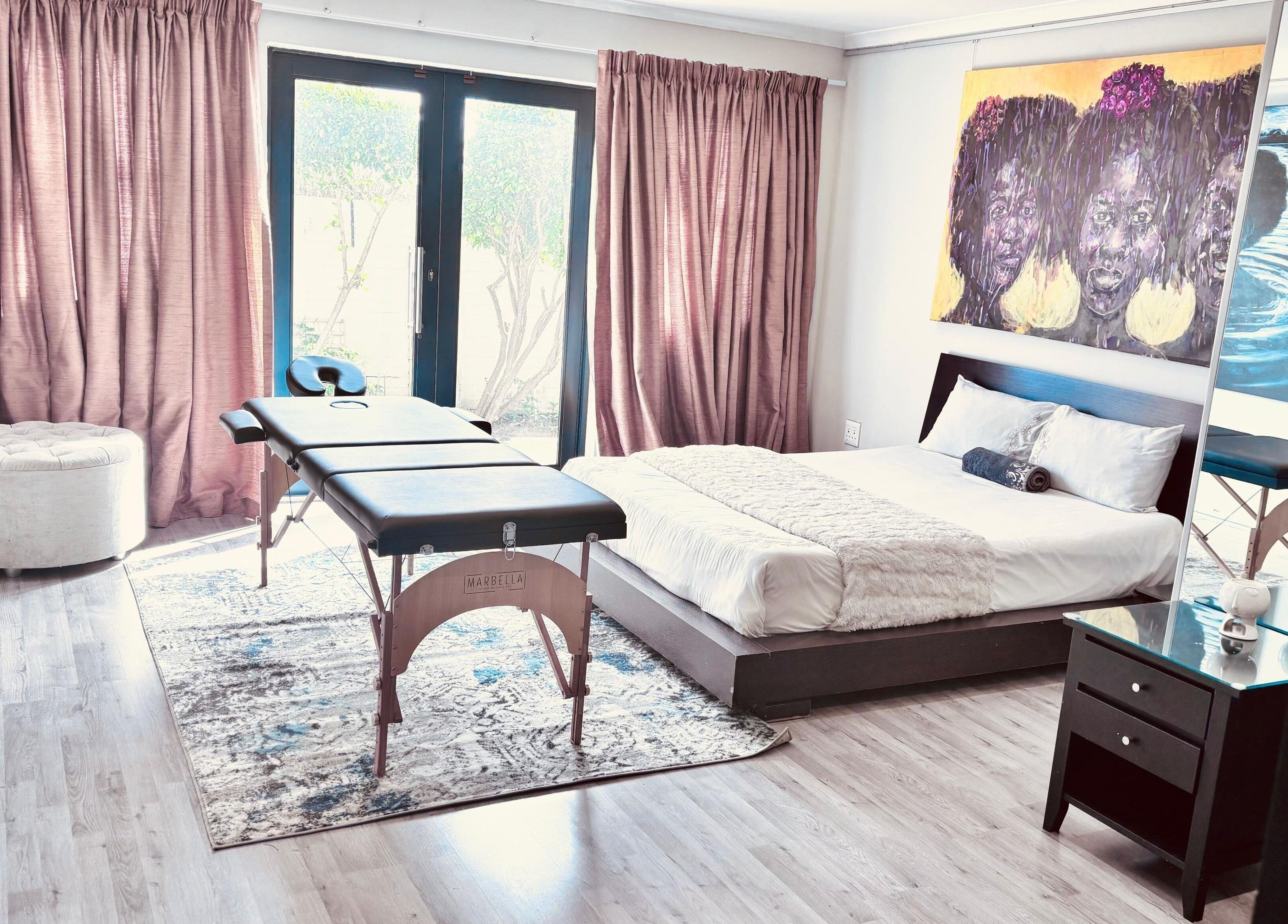 Serene treatment room at Chalila Wellness, Cape Town, Western Cape, ZA with cozy bed and massage table.