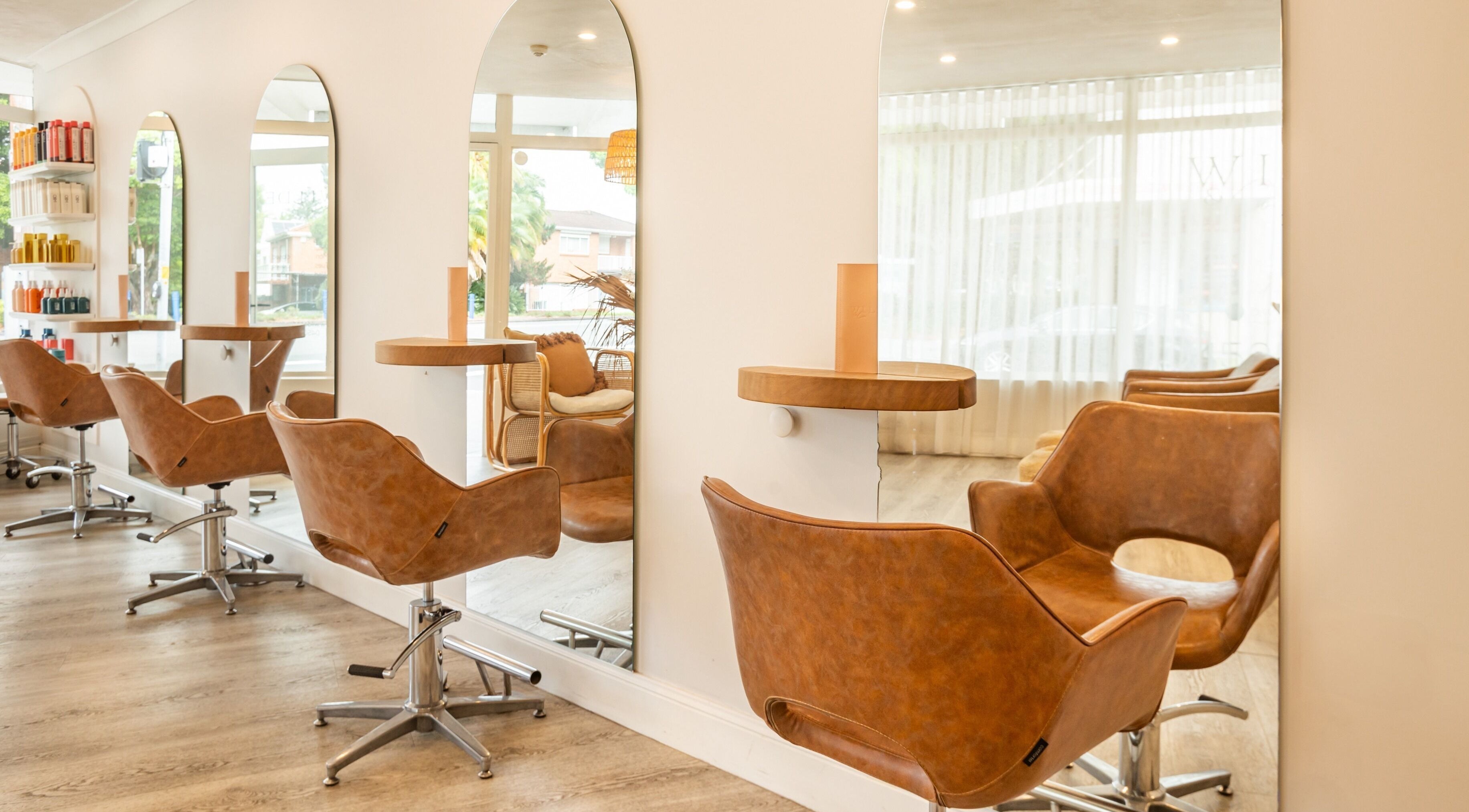 Chic seating area at Wilde and Co Hair Artistry, Kingsford, New South Wales, AU with elegant mirrors and chairs.