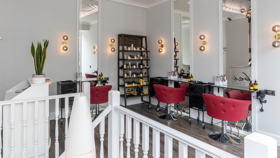 Luxurious salon interior at bei London, London, England, GB with modern decor and red seating.