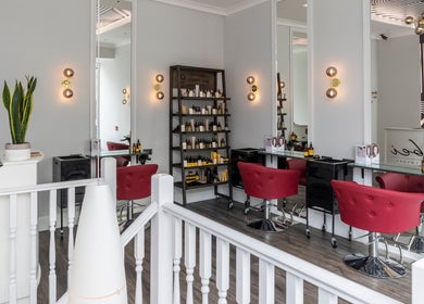 Luxurious salon interior at bei London, London, England, GB with modern decor and red seating.
