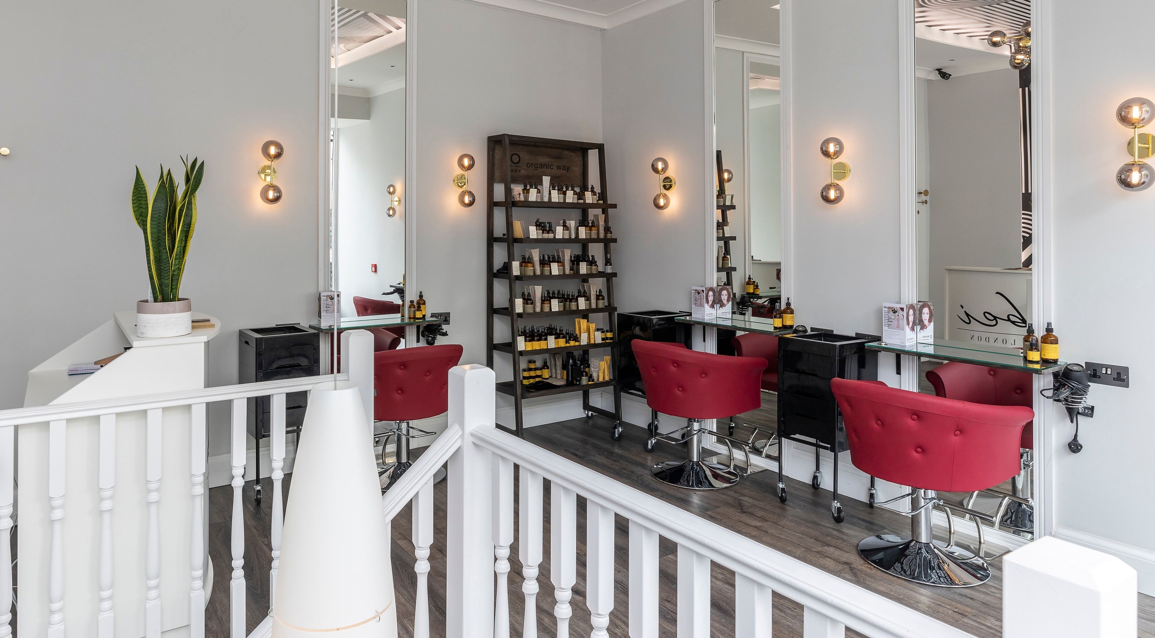 Luxurious salon interior at bei London, London, England, GB with modern decor and red seating.