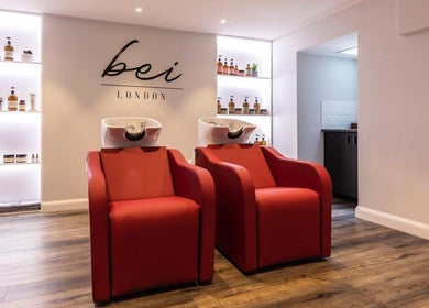 Modern red salon chairs at bei London, a chic beauty venue in London, England, GB.