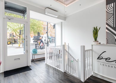 Modern entrance of bei London in London, England, GB showcasing stylish decor and natural light.
