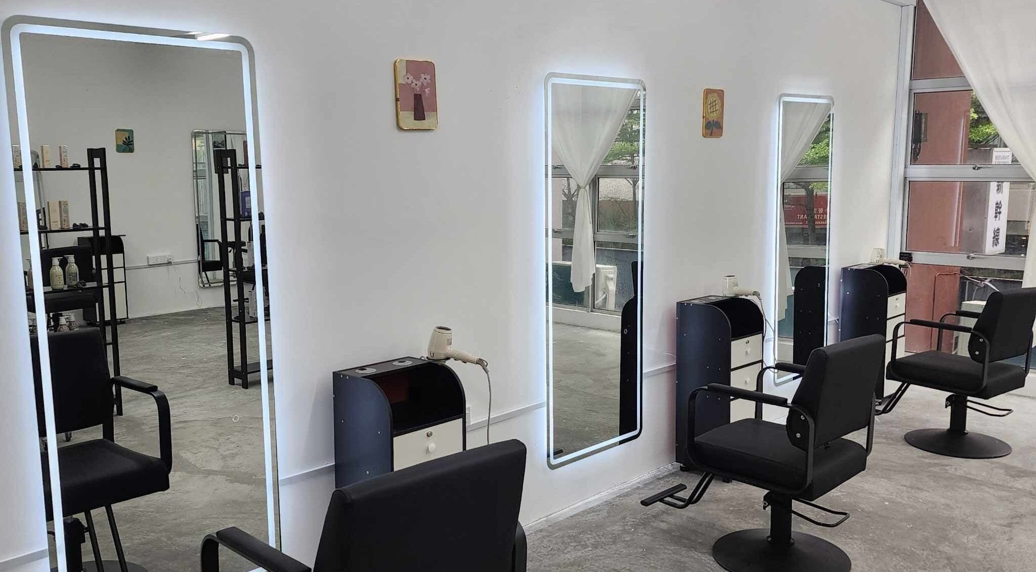 Modern salon interior at PLAN A HAIR SALON in Masai, Johor, MY featuring sleek styling stations and chairs.