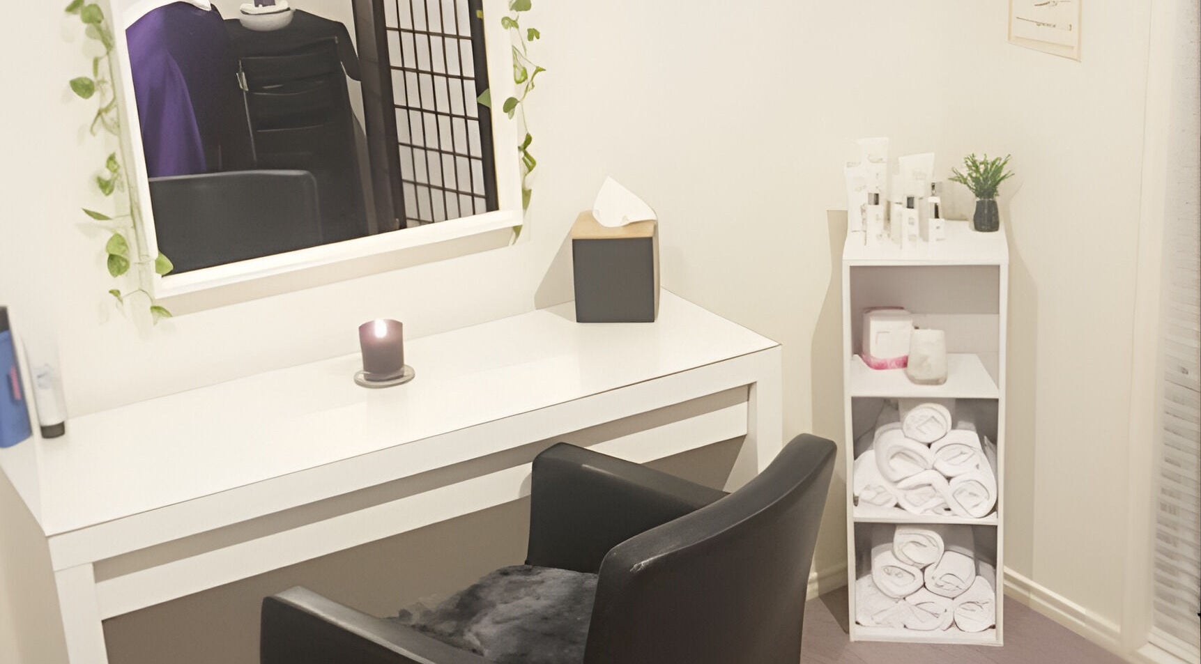 Cozy treatment space at Bliss Beauty Bar, Strathpine, Queensland, AU with candles and neatly arranged towels.