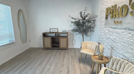 Elegant lobby at Piko’s Spa in Sarasota, Florida, US with plush chairs and minimalist decor.