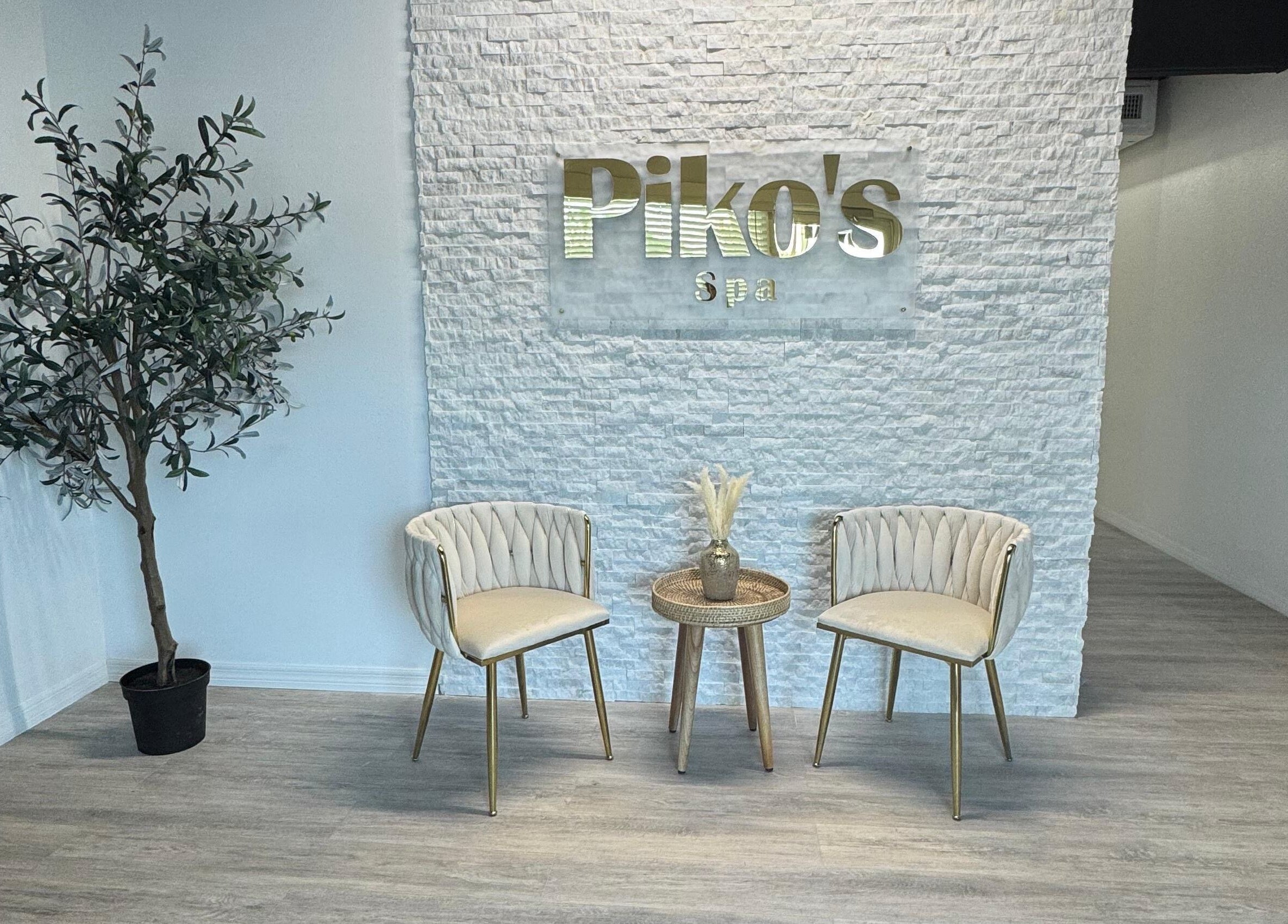 Elegant waiting area at Piko’s Spa in Sarasota, Florida, US with chairs and a plant for a calming ambiance.