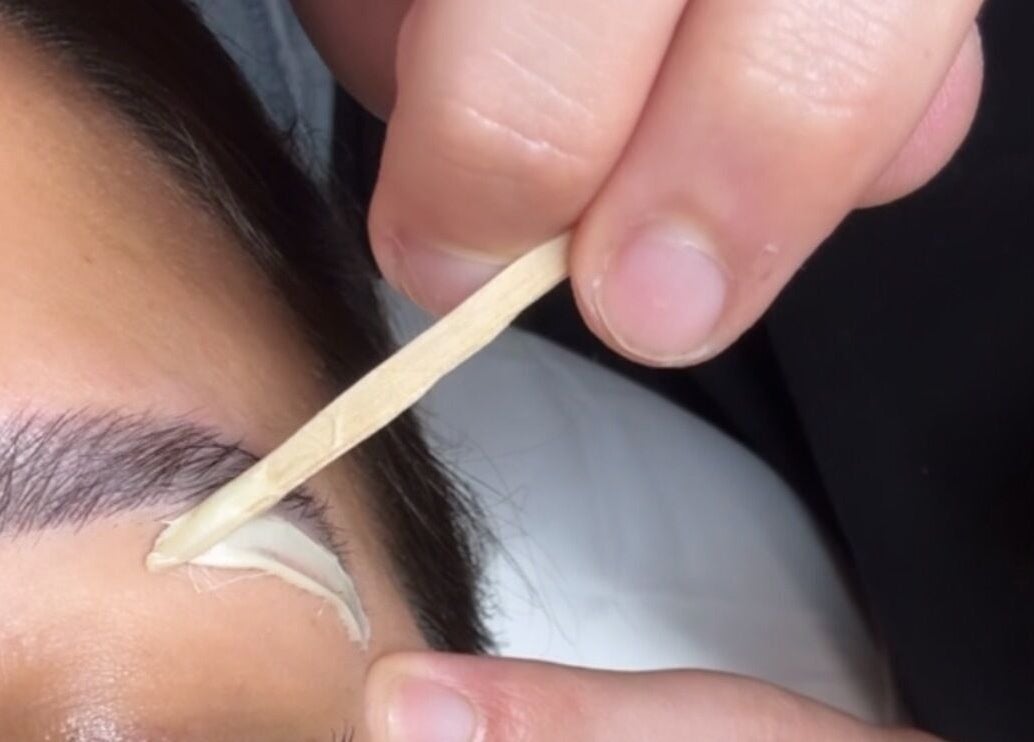 Brow waxing at Piko’s Spa in Sarasota, Florida, US, showcasing precise grooming technique.