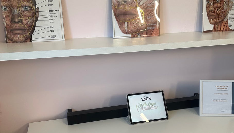 Interior view of KalliJayne Aesthetics in Margate, England, showcasing educational facial anatomy diagrams on a shelf.