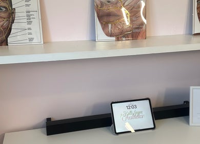 Interior view of KalliJayne Aesthetics in Margate, England, showcasing educational facial anatomy diagrams on a shelf.