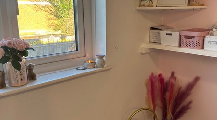 Interior view of KalliJayne Aesthetics in Margate, England, GB, showcasing chic shelves and floral decor.