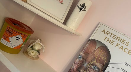 Decorative shelf with a floral display at KalliJayne Aesthetics in Margate, England, GB.