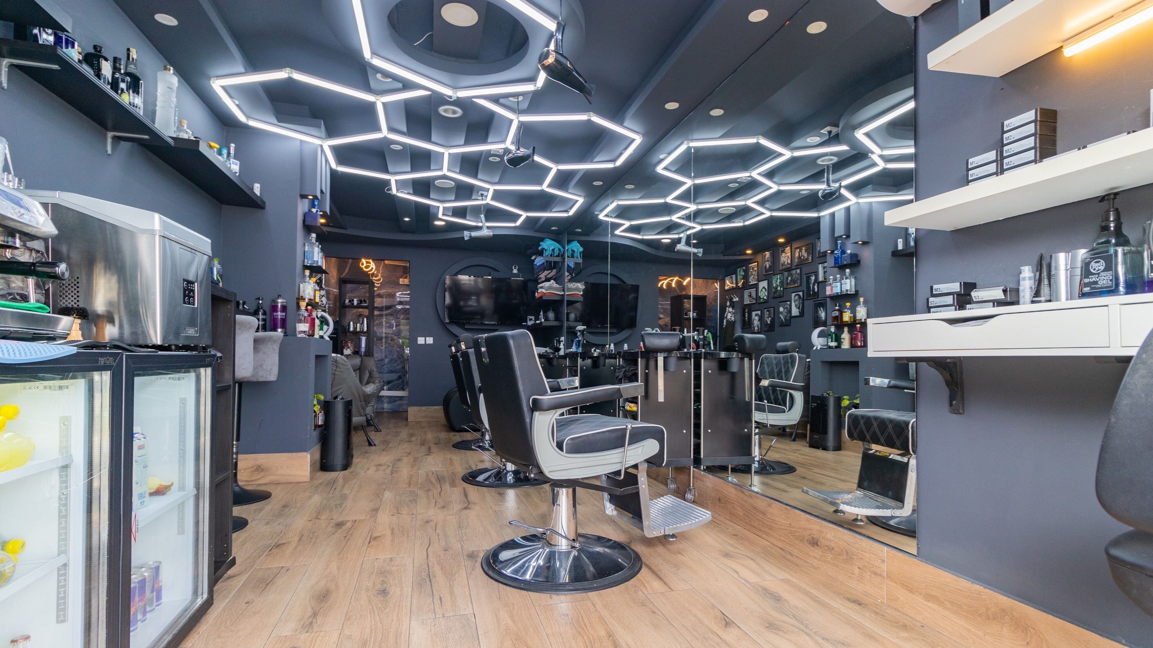 Modern barber interior at PLAN B | BALLUTA in Sliema, MT with stylish seating and hexagonal lighting.