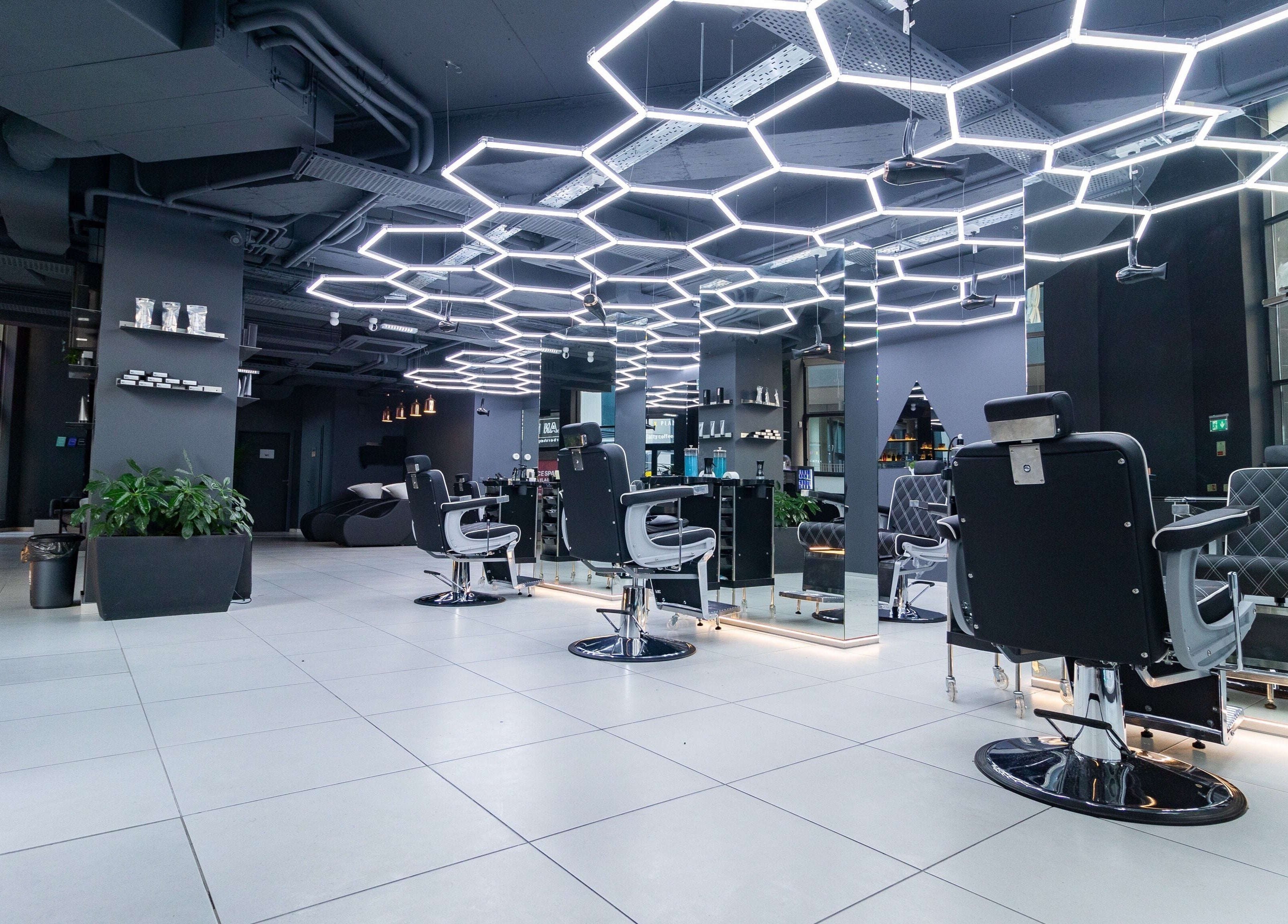 Modern salon interior at PLAN B | Mercury (St. Julian’s), San Ġiljan, MT with stylish chairs and lighting.