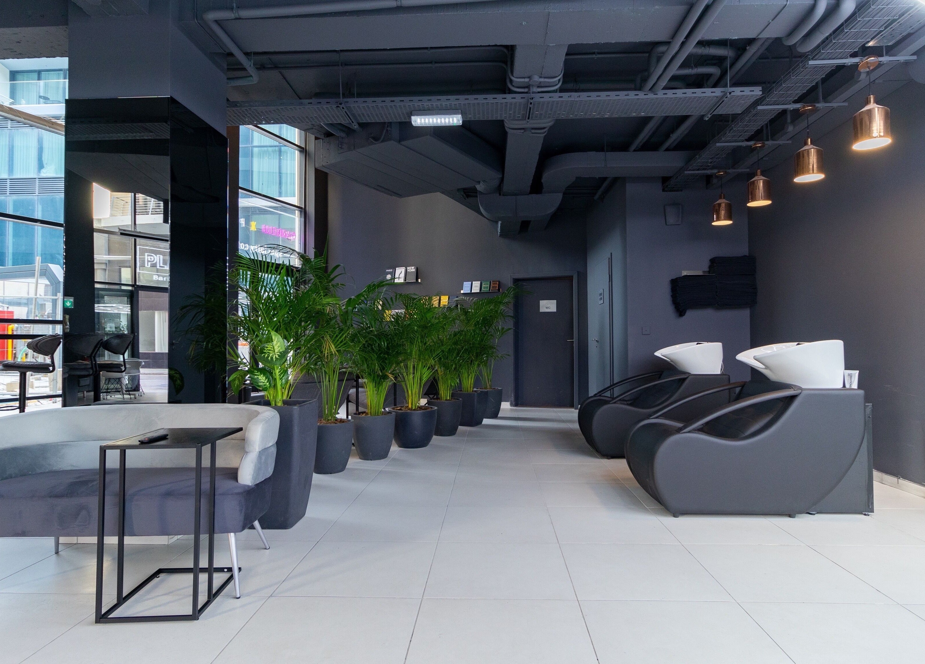 Stylish seating area at PLAN B | Mercury (St. Julian’s), San Ġiljan, MT, with modern decor and greenery.