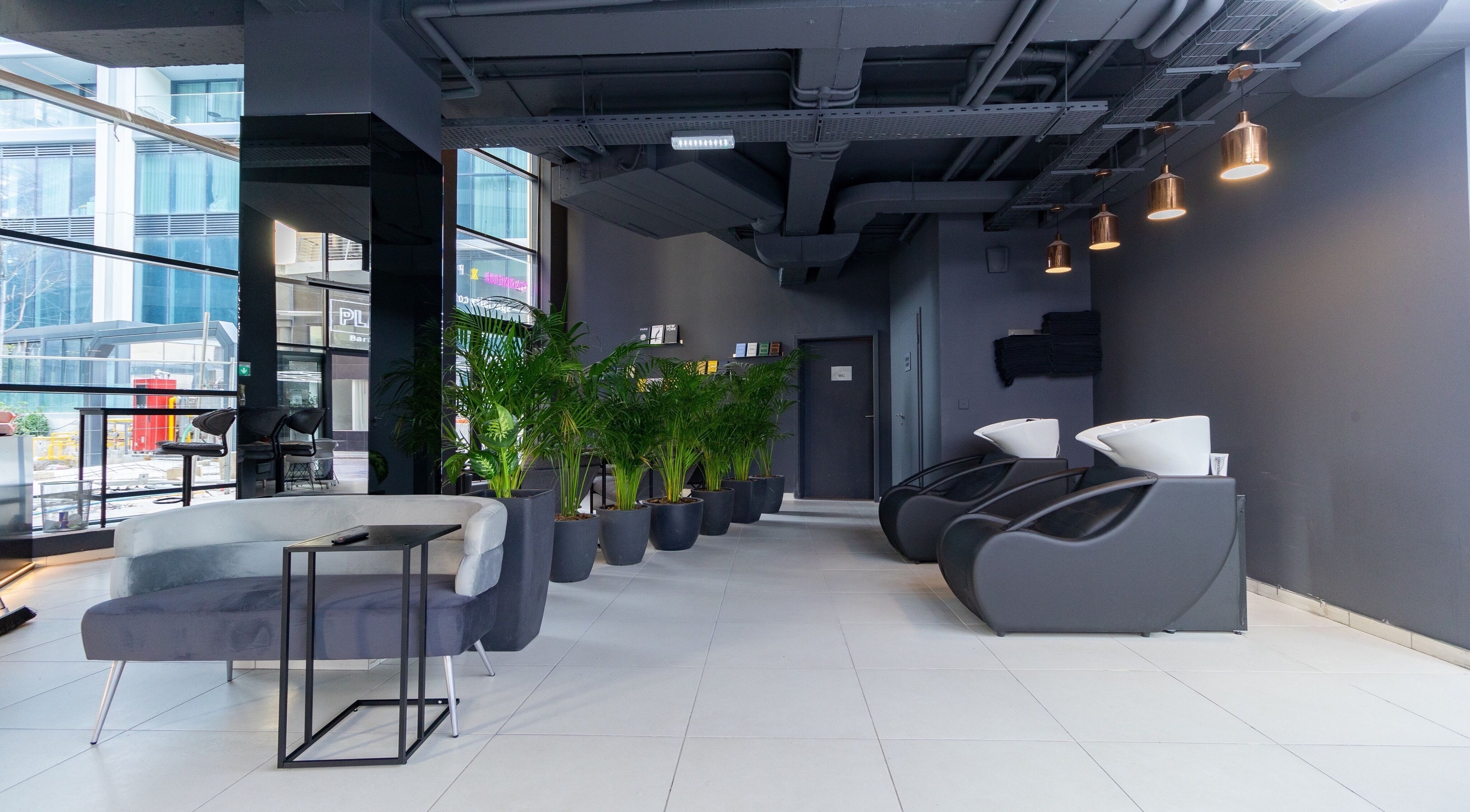 Stylish seating area at PLAN B | Mercury (St. Julian’s), San Ġiljan, MT, with modern decor and greenery.