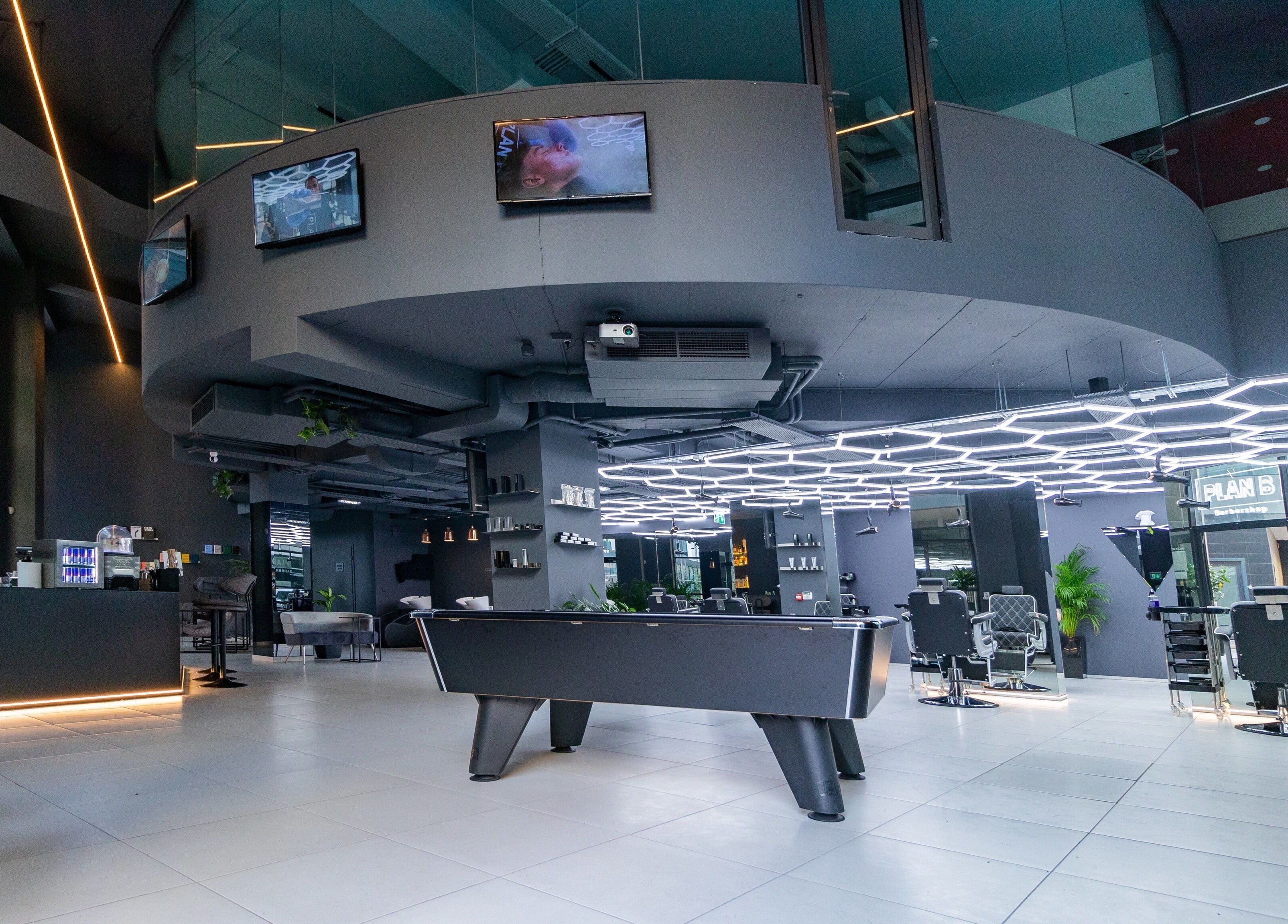 Modern interior of PLAN B | Mercury (St. Julian’s) salon, San Ġiljan, MT with sleek design and pool table.